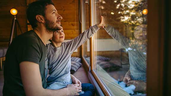 Father and Son Looking Out of the Window